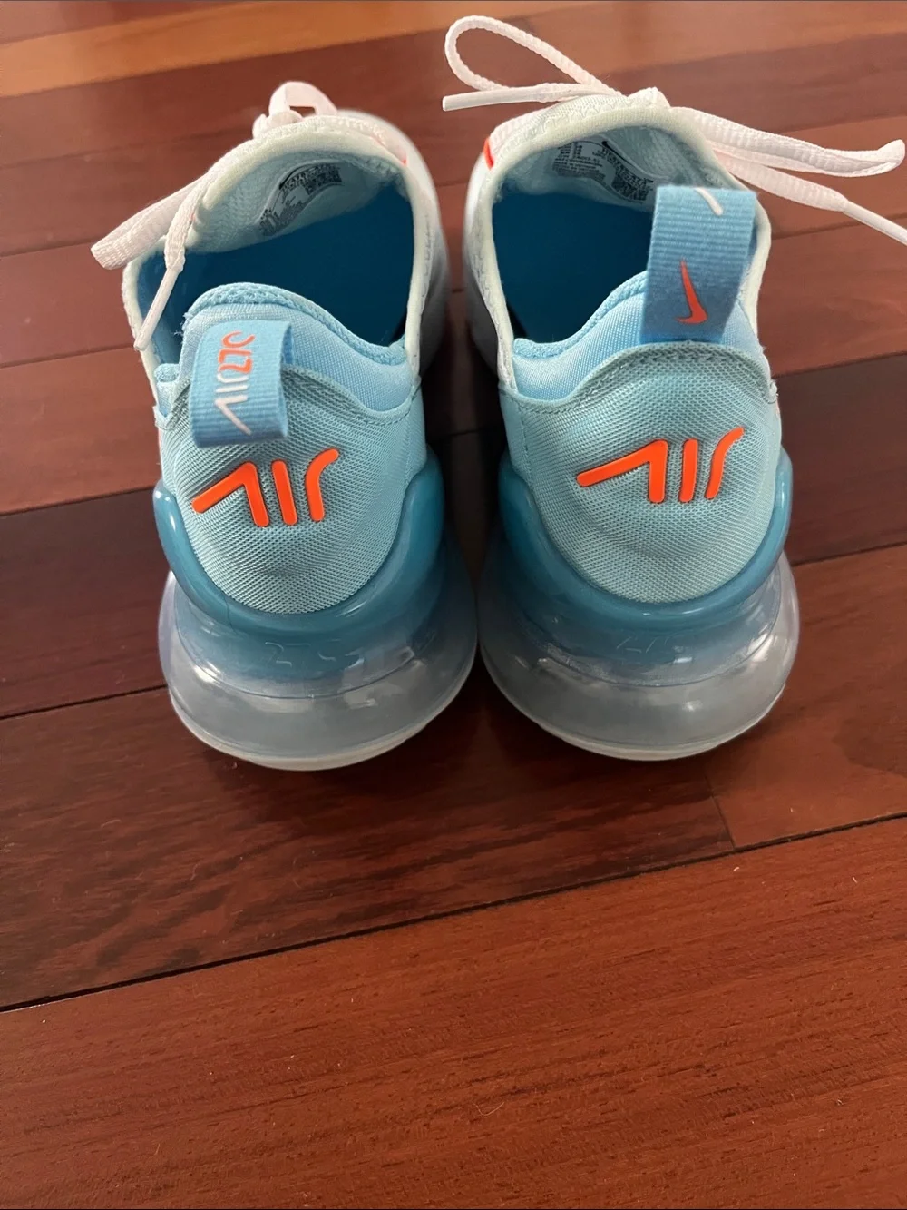 Nike Women’s Light Blue Sneakers with Orange Accents
